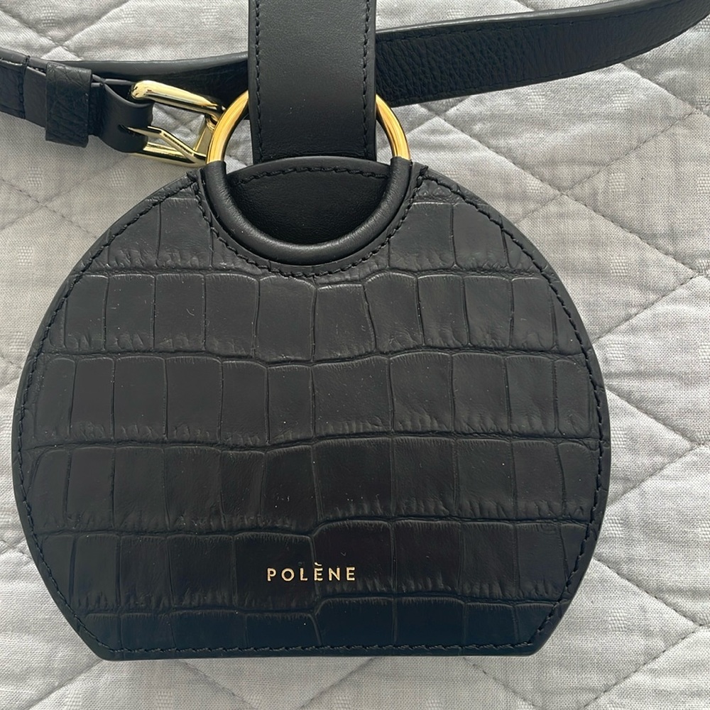 Black small bag with belt to hold around your waist by Polene